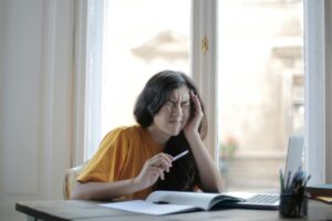 A woman trying to work dealing with a migraine