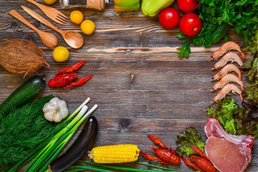 Learning how to eat a variety of foods, like the spread of seafood, steak, and colorful vegetables pictured here, can lead to improved health.