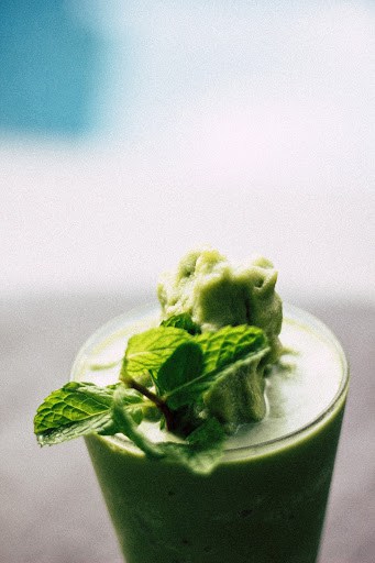 Glass of green smoothie with mint
