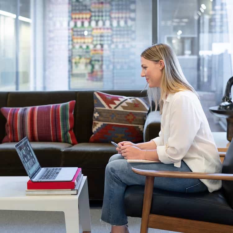 Woman participating in an online video call on her laptop