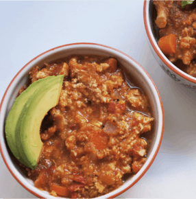 Bowl of sweet potato chili with avocado