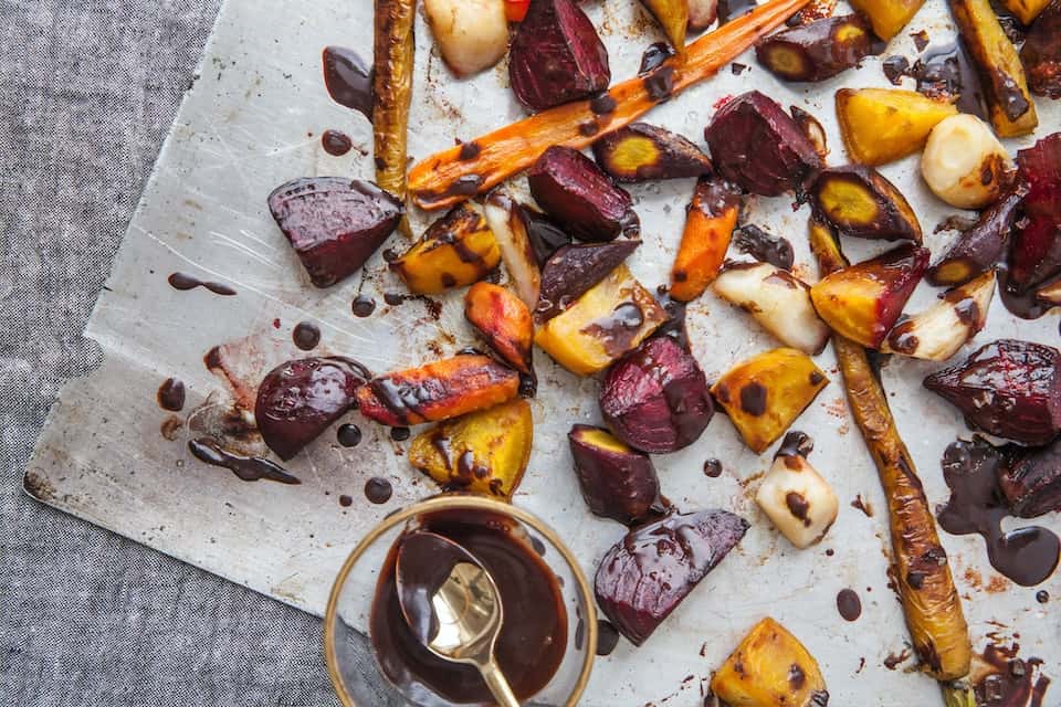 Various roasted root vegetables on parchment paper