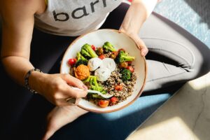 A woman eating a healthy salad bowl